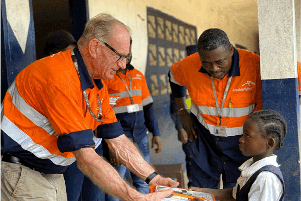 AML-CEO-Jozephus-Coenen-presents-branded-educational-material-to-a-student-in-Grand-Bassa-County