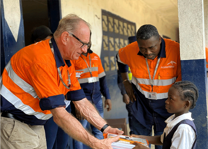 AML-CEO-Jozephus-Coenen-presents-branded-educational-material-to-a-student-in-Grand-Bassa-County