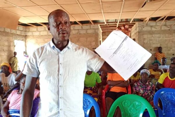 Spokesman of Aggrieved Citizens Displaying Original Land Deed