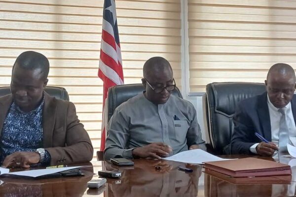 Executive-Director-Andrew-Peters-NIR,-Abdullah-L.-Kamara,-LTA-Acting-Chairman,-and-Abdullah-S.-Swaray,-NICOL-Managing-Director,-signing-for-their-respective-entities.