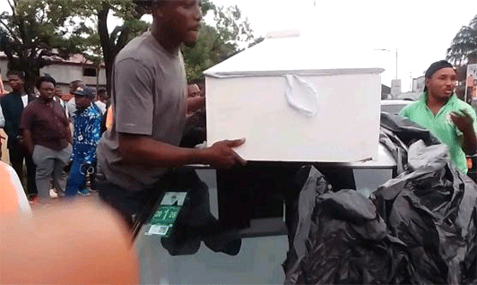Police-Officers-Taking-Hold-Of-Woman’s-Coffin