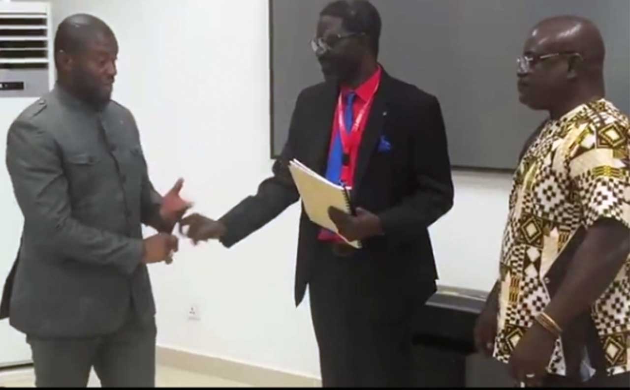 Josiah-Joekai-submitting-the-report-to-Deputy-Minister-Karpeh.